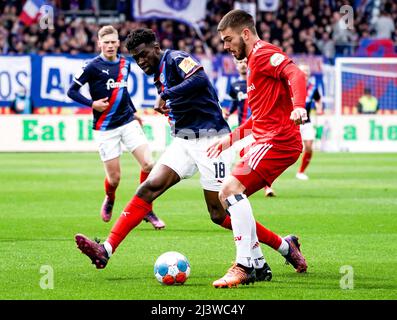Kiel, Germania. 10th Apr 2022. Calcio: 2nd Bundesliga, Holstein Kiel - Hamburger SV, Matchday 29, Holstein Stadium. Kwasi Okyere Wriedt di Kiel (l) e Mario Vuskovic di Amburgo lottano per la palla. Credit: Axel Heimken/dpa - NOTA IMPORTANTE: In conformità con i requisiti della DFL Deutsche Fußball Liga e della DFB Deutscher Fußball-Bund, è vietato utilizzare o utilizzare fotografie scattate nello stadio e/o della partita sotto forma di immagini di sequenza e/o serie di foto video-simili./dpa/Alamy Live News Foto Stock