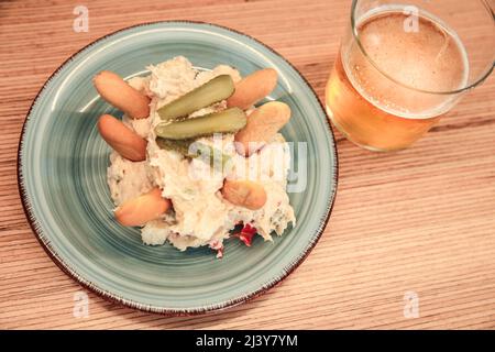 Tapa di insalate russe accanto alla birra fredda su un banco bar spagnolo Foto Stock