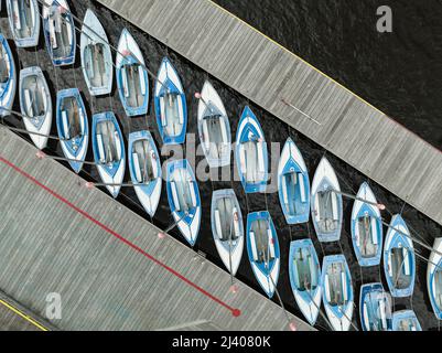 File di barche a vela blu e bianche ormeggiate vicino al fiume Charles in vista aerea di Boston Foto Stock