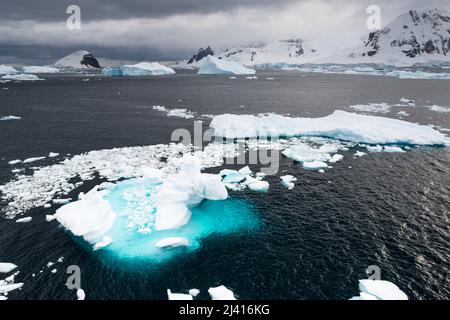 Guardando a ovest da Danco Island, canale di Errera, verso le isole che delimitano lo stretto di Gerlache, con iceberg, isole e ghiaccio di deriva. Antartide Foto Stock