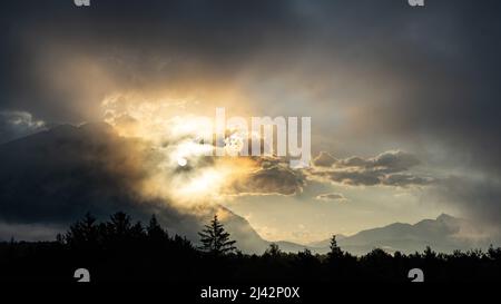 La luce del mattino presto in un'alta valle di montagna in Austria illumina le nuvole e la nebbia Foto Stock