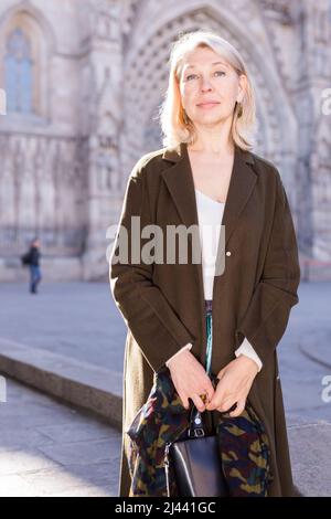 Elegante donna anziana gode di una vista sulla città vecchia Foto Stock