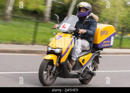 Getir pilota di consegna ultraveloce consegna generi alimentari in pochi minuti su uno scooter Super Soco CPx Foto Stock