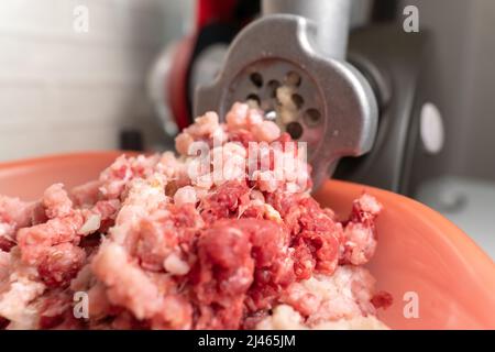 Macinacaffè e carne macinata caduta. Messa a fuoco selettiva. Cibo fatto in casa Foto Stock