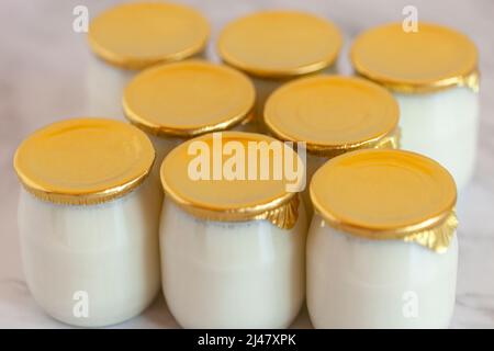 yogurt industriale al latte intero naturale in pentole di vetro senza data di scadenza Foto Stock