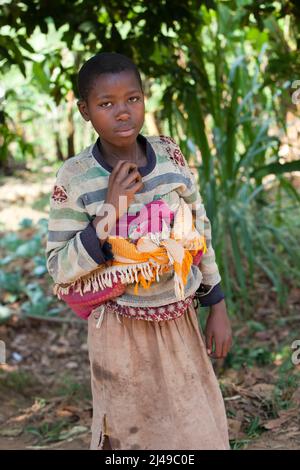 Triphonie Bosenibo, 36 anni, marito Daniel Bwanakweri, 45 anni, e ha 7 figli. Il 5 presente Jean Didier Dufatanye, 18, Sandrine Umuruta Satte, 12, Jean D'Amour Niyonkwizera, 9, Emmanuel Niyonshuti, 7, e Valentine Umutesi, 18 mesi. Una volta mangiavano una volta al giorno e spesso vanno affamati, lavorando un lavoratore salariale sulla terra di altre persone. Ora mangiano due o tre volte al giorno, compresi i vegitable, e il marito dice che non pensa mai di lavorare per altre persone. Foto Stock