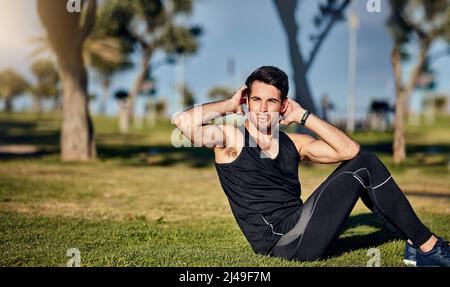 Il corpo raggiunge ciò che la mente crede. Scatto di un giovane uomo in gymwear che si allena in un parco. Foto Stock