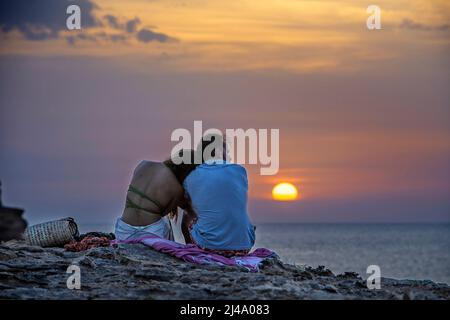 Romantico tramonto di coppia a Cala Saona al tramonto spiagge più belle del mediterraneo, Isole Baleari Formentera, Spagna Foto Stock