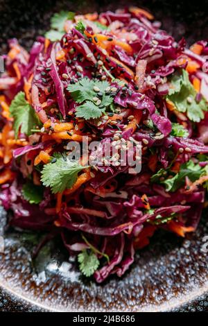 Insalata di cavolo rosso in un grande piatto testurizzato, vista dall'alto Foto Stock