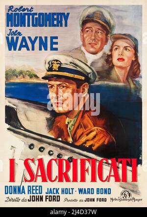 JOHN WAYNE, ROBERT MONTGOMERY e DONNA REED in LORO ERANO SPENDIBILI (1945), diretto da JOHN FORD. Credito: M.G.M. / Album Foto Stock