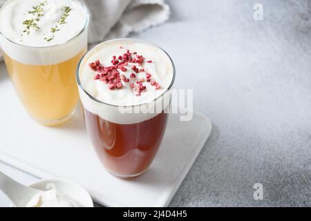 Bevande asiatiche cinesi, formaggio oolong e tè nero con strato di schiuma di formaggio cremoso sormontato. Primo piano. Spazio di copia. Foto Stock