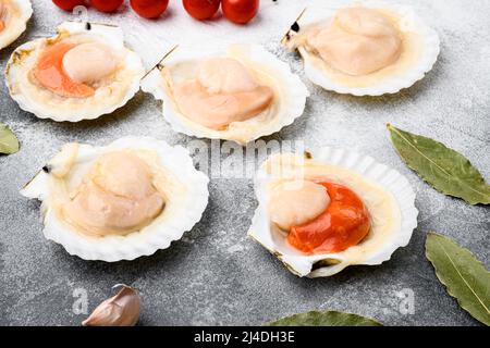 Conchiglia di capesante scottate con burro, aglio, su sfondo grigio da tavolo in pietra Foto Stock