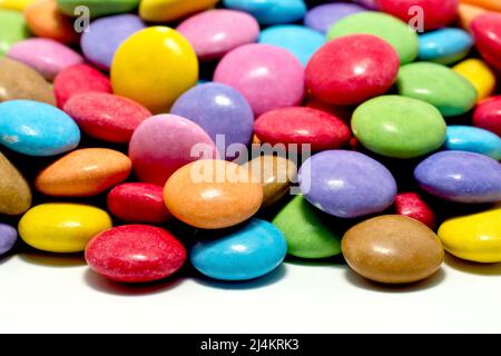 Primo piano di un mucchio di caramelle al cioccolato multicolore e croccanti. Foto Stock