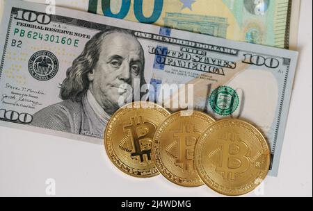 Il bitcoin d'oro giace su banconote diverse. Cryptocyrency confrontare con il nuovo denaro virtuale. Euro in dollari USA e altri contanti Foto Stock