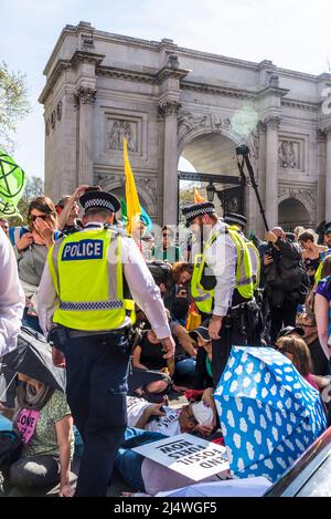 La polizia incontrata che si impegna con i manifestanti su strada bloccati da un sit-in a non saremo spettatori, una protesta della ribellione di estinzione che combatte per il clima Foto Stock