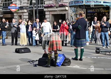 Londra, UK, Pasqua Lunedì, 18th Aprile 2022, Meteo. Caldo sole durante le feste di banca. I baffle di Piccadilly Circus si preparano a dare una rendita di musica scozzese a una folla di spettatori. Credit: Paul Biggins/Alamy Live News Foto Stock