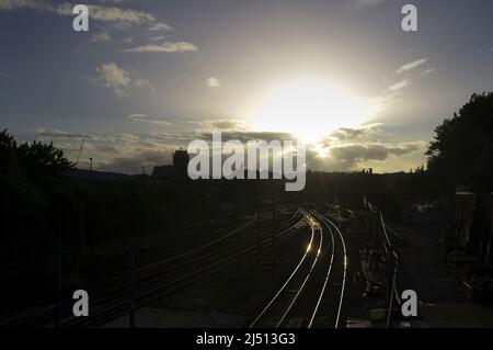 Luce serale riflessa dai binari del treno Kentish Town Road, Kentish Town, Londra, Regno Unito. 10 maggio 2014 Foto Stock