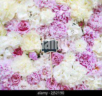 Etichetta in lavagna vuota su sfondo floreale con peonie, rose e ortensie. Risorse grafiche Foto Stock