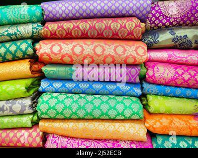 Rotoli di tessuto e tessuti in negozio. Multi colori motivi indiani sul mercato tessuti in rotoli. Negozio di tessuti a Pune, Maharashtra, India. Foto Stock