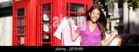 Shopping donna felice a Londra a piedi su Oxford Street con molti sacchetti rosa negozio da vendita negozio. Modello ragazza sorridente fuori su shopping estate spree Foto Stock