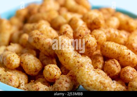 Spuntini alle arachidi di mais soffiato sul piatto. Primo piano. Foto Stock