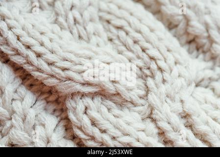 tessuto angora lavorato a maglia. tessuto lana beige. Fondo in maglia con motivo a rilievo per carta da parati e sfondo astratto. Lana mano- Foto Stock