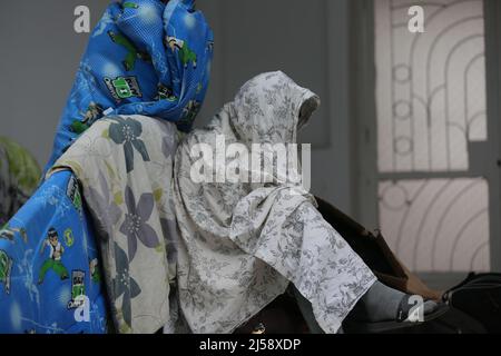 Tunisia. 21st Apr 2022. Decine di rifugiati e migranti in Tunisia chiedono evacuazione in altri paesi. I rifugiati, per lo più sopravvissuti ai tentativi di immigrazione clandestina via mare in Europa, hanno organizzato un sit-in davanti all'ufficio dell'Alto Commissariato delle Nazioni Unite per i rifugiati (UNHCR) nella capitale tunisina, Tunisi da sabato.'dobbiamo essere evacuati,' legge un banner che hanno appeso all'ingresso dell'edificio di Tunisi, Tunisia, il 21 aprile 2022. (Foto di Mohamed KRIT/ Credit: Sipa USA/Alamy Live News Foto Stock