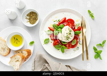 Insalata caprese con pomodoro, mozzarella e basilico, cucina italiana Foto Stock