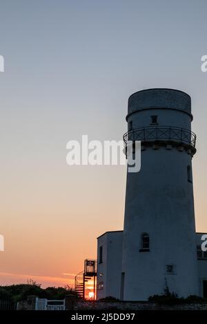 L'iconico faro di Old Hunstanton al tramonto. Foto Stock