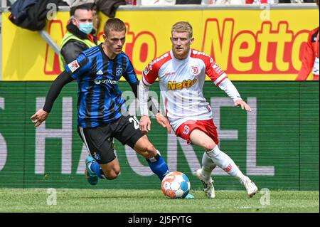 Regensburg, Germania. 23rd Apr 2022. Calcio: 2nd Bundesliga, Jahn Regensburg - Hamburger SV, Matchday 31, Jahnstadion Regensburg. Jan-Niklas Beste di Regensburg (r) combatte per la palla con Miro Muheim di Amburgo. Credit: Armin Weigel/dpa - NOTA IMPORTANTE: In conformità con i requisiti della DFL Deutsche Fußball Liga e della DFB Deutscher Fußball-Bund, è vietato utilizzare o utilizzare fotografie scattate nello stadio e/o della partita sotto forma di immagini di sequenza e/o serie di foto video-simili./dpa/Alamy Live News Foto Stock