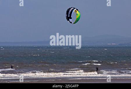 Portobello, Edimburgo, Scozia, Regno Unito. 23rd aprile 2022. Kitesurfers fuori sul Firth di Forth a porty, insolito a kitesurf qui ma a causa del vento che arriva da ENE 31km/h con raffiche potenzialmente 42 km/h e temperatura di 12 gradi ha dato le condizioni ideali affinchè alcuni kitesurfers uscire sulla superficie instabile. Foto Stock