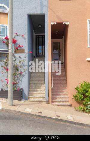 Case di quartiere con scala alla porta d'ingresso su un pendio di cemento zona residenziale. San Francisco residenze in California con piante al f Foto Stock