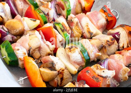 tacchino leggermente arrostito sgranò il kebab su spiedini di metallo, con un sacco di verdure colorate, pronto per la preparazione. Cibo delizioso, leggero e dall'aspetto fantastico Foto Stock