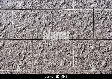 Sfondo da un muro con lastre rettangolari in pietra grigia Foto Stock