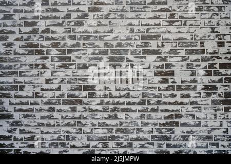 Sfondo da un muro di mattoni grigi con un sacco di cemento sulla superficie Foto Stock