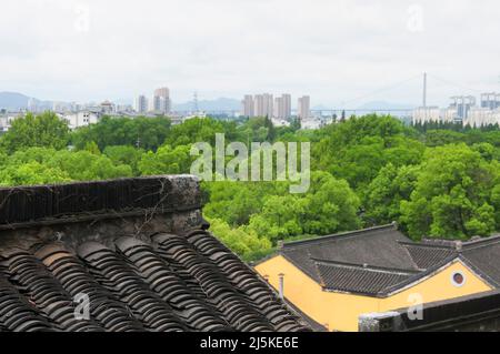 Si affaccia sui tetti del tempio di Jinshan con la città di Zhenjiang sullo sfondo in una giornata trascorsa nella provincia di Jiangsu. Foto Stock
