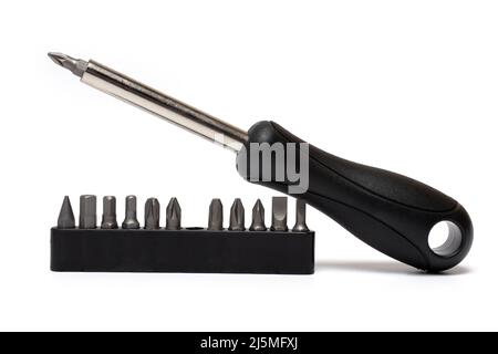 Primo piano di un cacciavite flessibile con varie punte con manico in gomma nera su sfondo bianco con una gamma di inserti diversi adatti per c Foto Stock