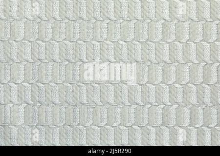 Tessitura a maglia. Struttura in tessuto jacquard con motivo geometrico grigio beige. Motivo a mosaico a crochet. Foto Stock