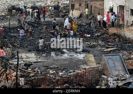 New Delhi, Delhi, India. 25th Apr 2022. La gente che raccoglie le loro cose di sinistra dopo che un fuoco massiccio si rompe intorno 04:00 PM alla zona di Dhobi Ghat di Jamia Nagar vicino Batla Casa, quattro animali domestici e rickshaws sono stati bruciati anche nel fuoco, nessun danno segnalato il 25 aprile 2022 a Nuova Delhi, India. Le aste di fuoco sono state precipitate al posto per destare il fuoco. (Credit Image: © Mohsin Javed/Pacific Press via ZUMA Press Wire) Foto Stock