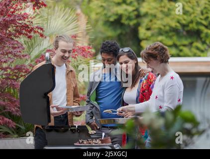 Amici di coppia felici al barbecue grill sul patio Foto Stock