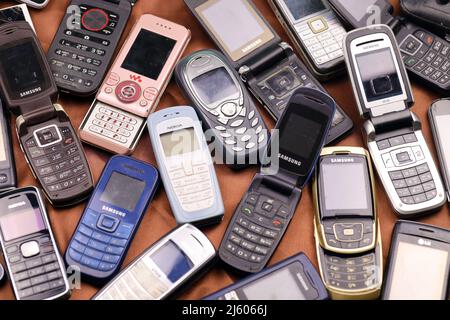 KHARKIV, UCRAINA - 16 DICEMBRE 2021: Alcuni vecchi hanno usato i telefoni cellulari obsoleti dal 90s-2000s periodo. Riciclare l'elettronica nel mercato a buon mercato Foto Stock