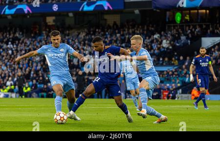 Manchester, Regno Unito. 27th Apr 2022. Il Real Madrid Rodygo Silva de Goes (C) è sfidato da due giocatori di Manchester City durante la semifinale a 1st posti della UEFA Champions League tra Manchester City e Real Madrid a Manchester, in Gran Bretagna, il 26 aprile 2022. Credit: Xinhua/Alamy Live News Foto Stock