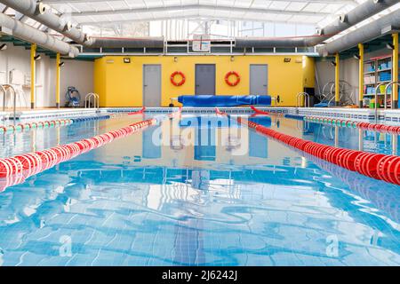 Piscina vuota con corsie di nuoto in acqua blu Foto Stock