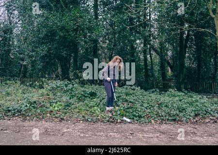 Giovane donna trekking nella foresta Foto Stock