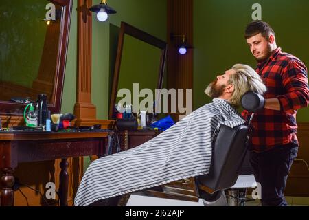 Barbiere e cliente professionali. Rifinire la barba da vicino. Migliora la tua esperienza di taglio dei capelli. Capelli del viso. Mantenere la forma della barba. Crescere la barba e. Foto Stock