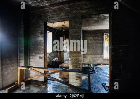 Interno casa in legno bruciato. Pareti incantate. Conseguenze del fuoco. Foto Stock