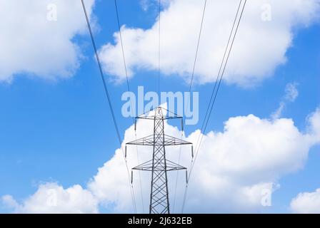 Elettricità pilone rete nazionale fornitore di energia elettrica contro un cielo blu soffice bianco nuvole Inghilterra GB Regno Unito Europa Foto Stock