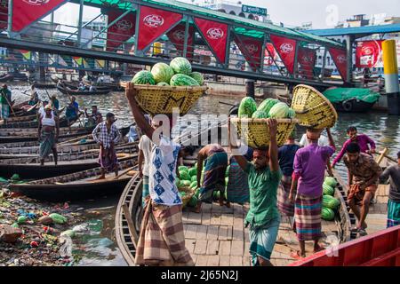 Anguria caricamento dalla barca per la vendita nel Bazar locale. Questa immagine è stata catturata dalla riva del fiume Burigongga il 24 aprile 2022, in D. Foto Stock