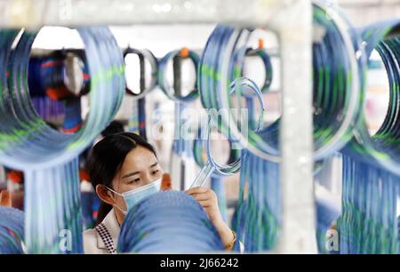 SUQIAN, CINA - 28 APRILE 2022 - Un lavoratore effettua ordini in un laboratorio di un racket di alta qualità in fibra di carbonio di badminton a Suqian, Jiangsu della Cina orientale Foto Stock