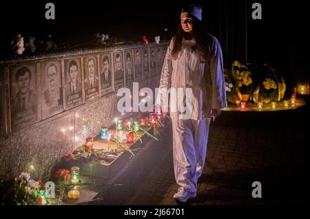 Slavutych, Ucraina. 26th Apr 2022. Un performer visto camminare vicino al Monumento agli Eroi di Chernobyl. Il 36th anniversario della catastrofe della centrale nucleare di Cernobyl si è verificato il 26th 1986 aprile (alle 01.23.40), è stato commemorato con una cerimonia pubblica a Slavutych (Ucraina), una città satellite costruita dopo la catastrofe, che ospita principalmente i lavoratori della centrale. Credit: SOPA Images Limited/Alamy Live News Foto Stock